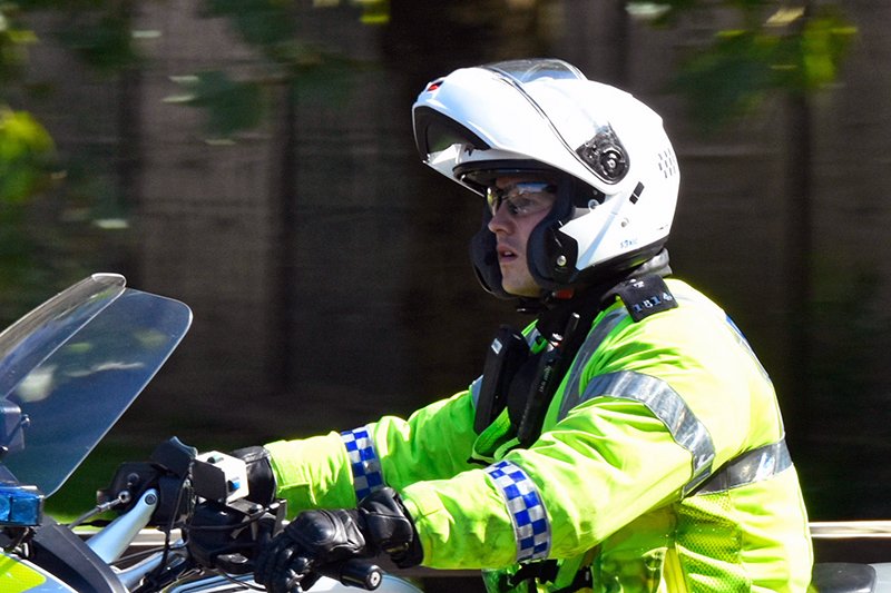 Police officer wearing flip lid motorcycle helmet
